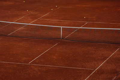 Hard tennis court with balls on field