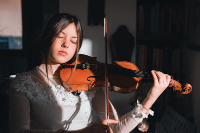 Beautiful young woman playing guitar