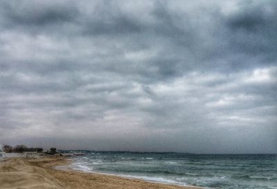 Scenic view of sea against cloudy sky