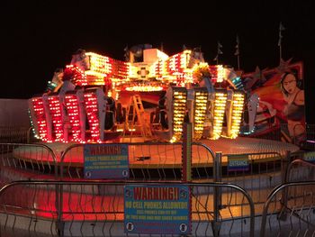 Low angle view of illuminated ferris wheel