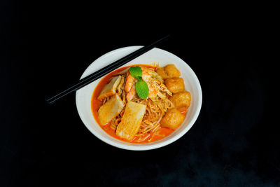 Close-up of food served against black background