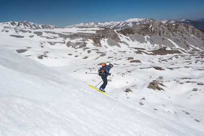 Man skiing on snow covered mountain