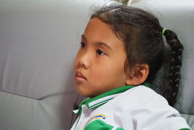 Portrait of cute boy looking away at home