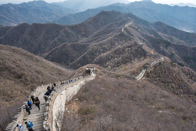 High angle view of tourists walking on mountain