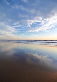 Scenic view of beach against sky during sunset