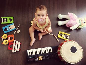 High angle view of cute boy playing with toy at home