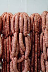 Close-up of roasted meat hanging at market stall