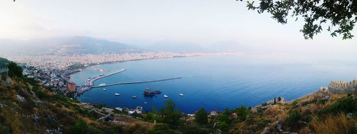 High angle view of sea and cityscape against sky