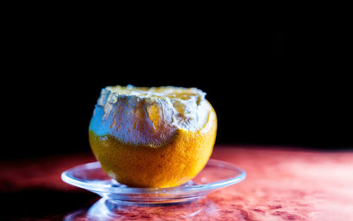 Close-up of drink on table against black background