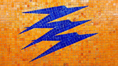 Close-up of arrow symbol on brick wall