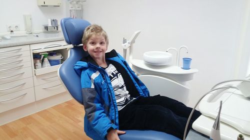 Portrait of boy sitting at dental clinic
