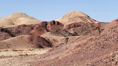 Scenic view of rocky mountains against clear sky in the desert 