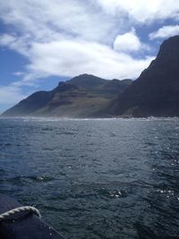 Scenic view of sea and mountains against sky