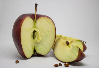 Close-up of apple on table against white background