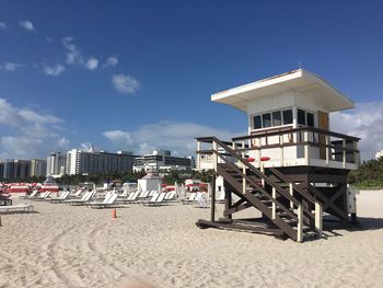 Lookout tower and deck chairs on sand