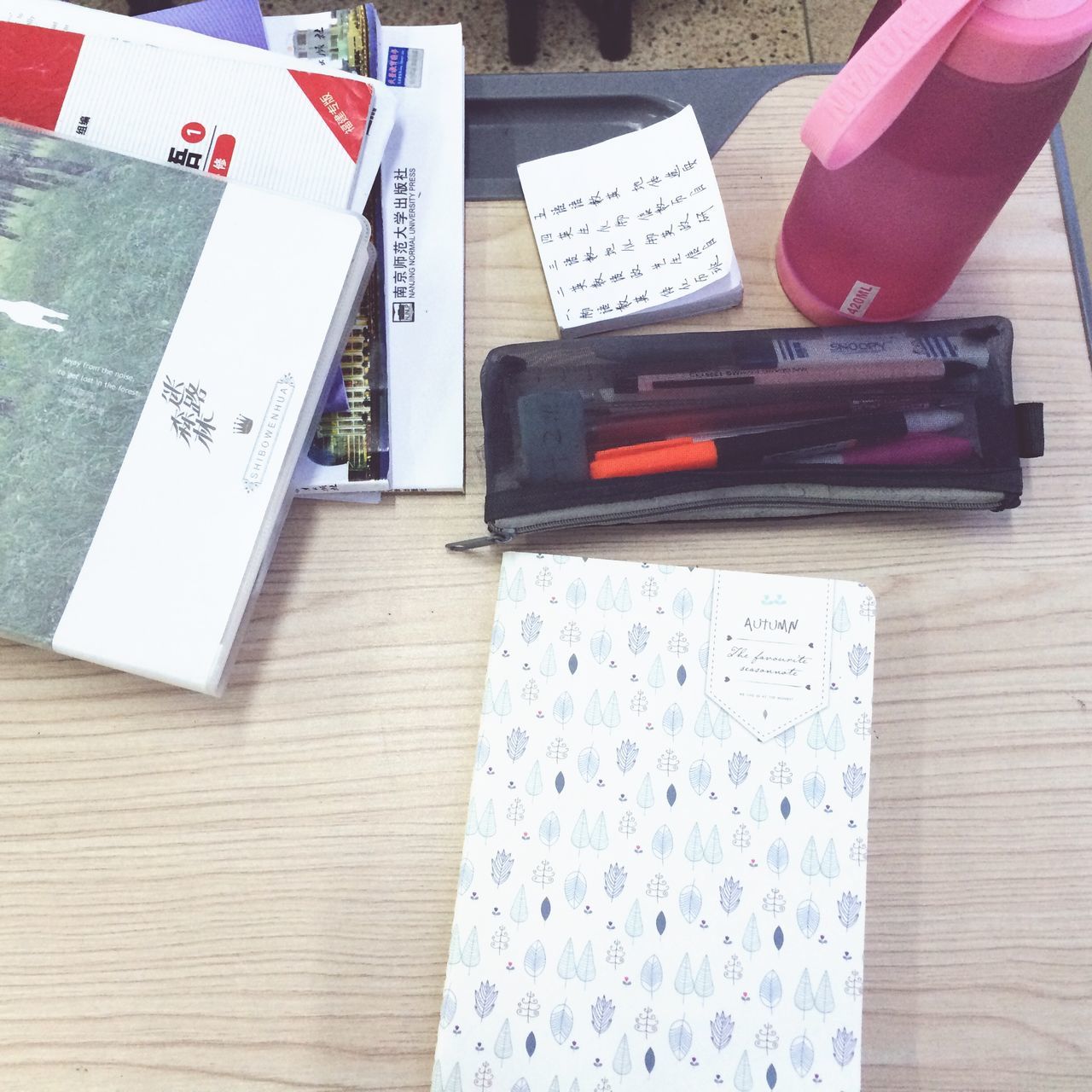 indoors, table, high angle view, paper, book, still life, communication, text, education, close-up, pen, wood - material, western script, pencil, document, learning, variation, page, no people, open