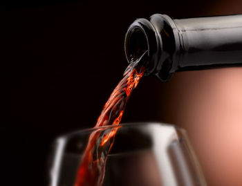 Close-up of drink pouring over black background