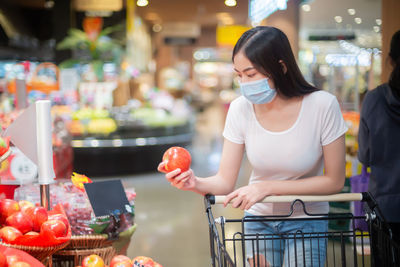 Woman standing by display at store