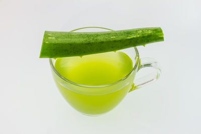 Close-up of green drink against white background
