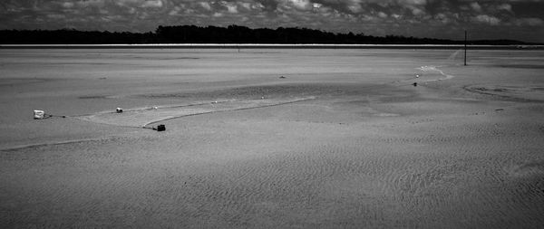 High angle view of wet land by lake against sky