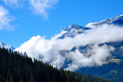 Scenic view of mountains against cloudy sky