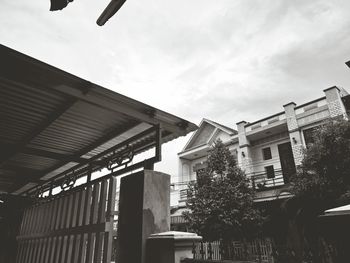 Buildings against cloudy sky