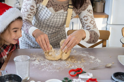 Midsection of woman preparing food at home