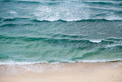Full frame shot of sea waves. high angle view of cristo rei backside beach in dili, timor leste. 