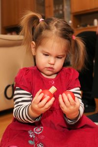 Cute girl playing with toy at home