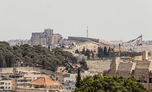 Buildings in city against clear sky