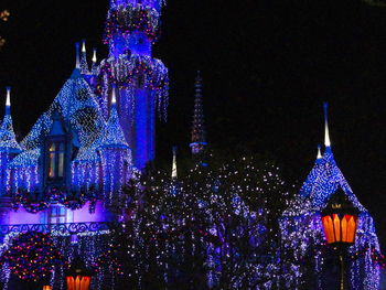 Low angle view of illuminated tower at night
