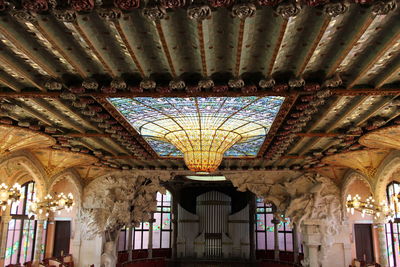 Low angle view of illuminated chandelier in building