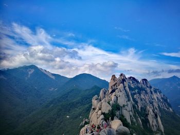 Scenic view of mountains against cloudy sky