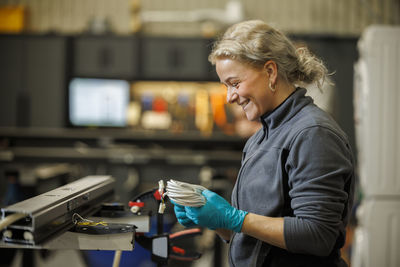 Young female industrial worker working in factory