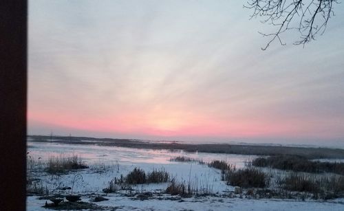 Scenic view of beach against sky during sunset