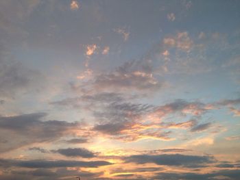 Low angle view of cloudy sky at sunset