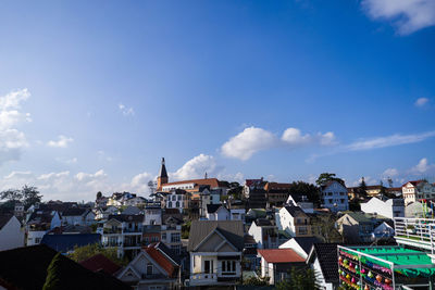 Buildings in city against blue sky