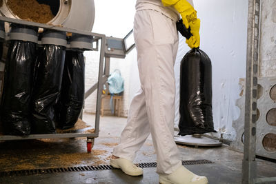 Low section of worker working at workshop