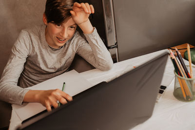 Midsection of woman using laptop on table