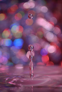 Close-up of drop falling on water