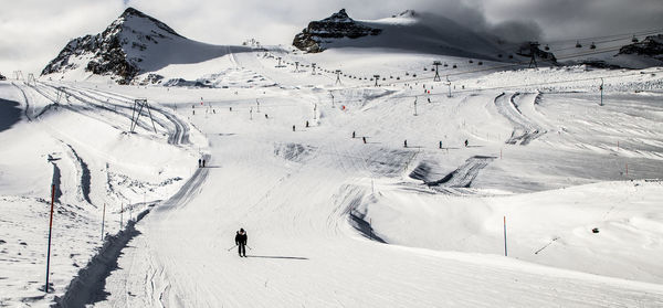 People skiing on snowcapped mountain