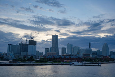 River by buildings against sky in city