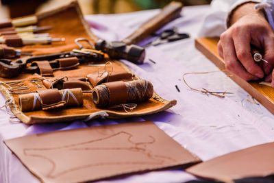 Cropped hands of craftsmanship with tools working on table