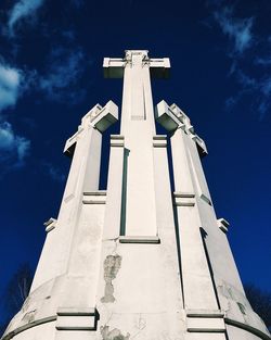 Low angle view of cross against sky