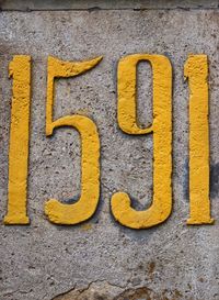 Close-up of yellow text on wall
