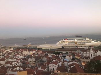 High angle view of townscape by sea against sky