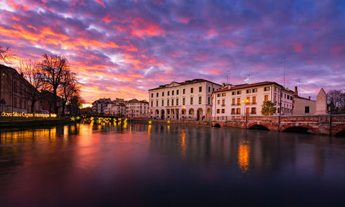 Landscape of the university building in treviso and the river sile at sunset on christmas time