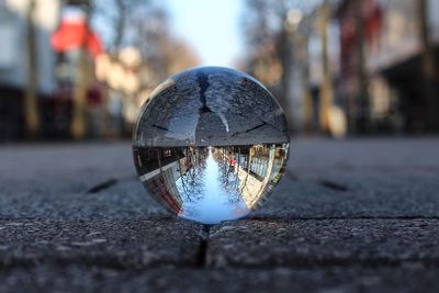 Close-up of crystal ball on street