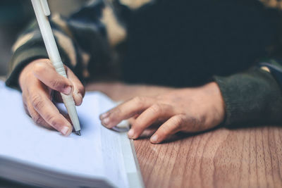 Close-up of human hand holding paper