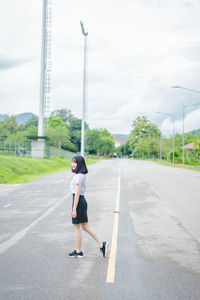 Full length of woman on road against sky